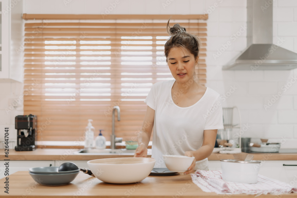 Asian woman preparing meal in the kitchen. Asian woman preparing meal in the kitchen.