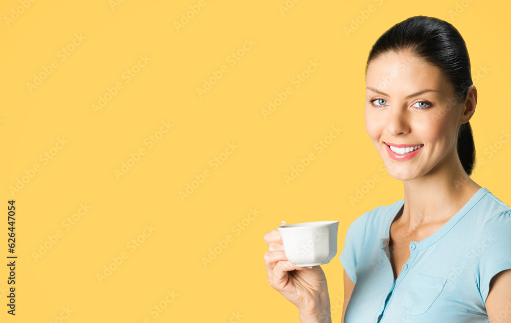 Portrait of young smiling brunette woman drinking coffee, isolated over orange yellow color background. Copy space blank area for some text or slogan. Portrait of young smiling brunette woman drinking coffee, isolated over orange yellow color background. Copy space blank area for some text or slogan.