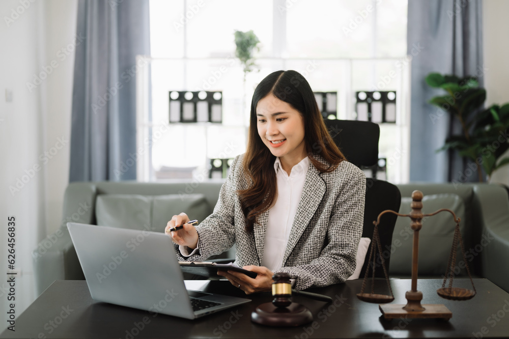 Beautiful asian woman lawyer working and gavel, tablet, laptop in front, Advice justice and law concept. in office. Beautiful asian woman lawyer working and gavel, tablet, laptop in front, Advice justice and law concept. in office.
