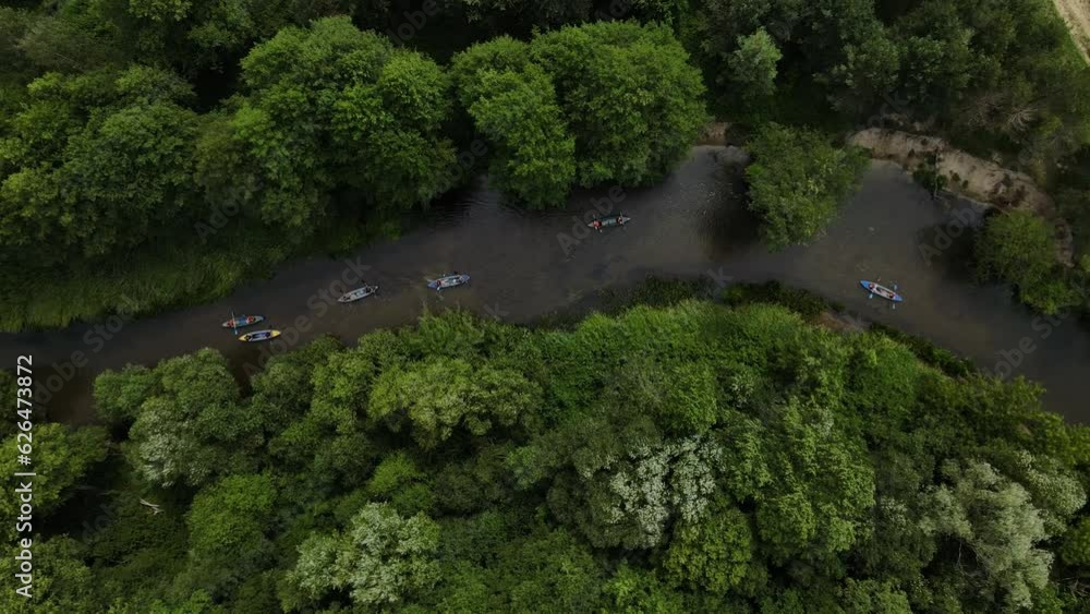 Aerial view: Kayak swimmers go down the river Aerial view: Kayak swimmers go down the river