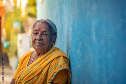 Indian Old Women Images. Portrait of indian old women Looking to the camera. Aged Old indian hindu women sitting on street.Old