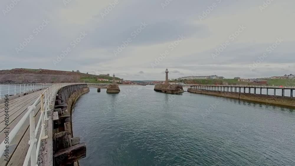 Whitby, North Yorkshire, UK – June 30 2023. The entrance to Whitby harbour on the North Yorkshire coast Whitby, North Yorkshire, UK – June 30 2023. The entrance to Whitby harbour on the North Yorkshire coast