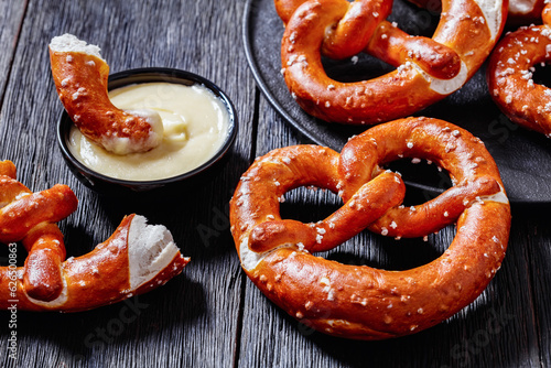 pretzels in the form of knot with cheese sauce photo