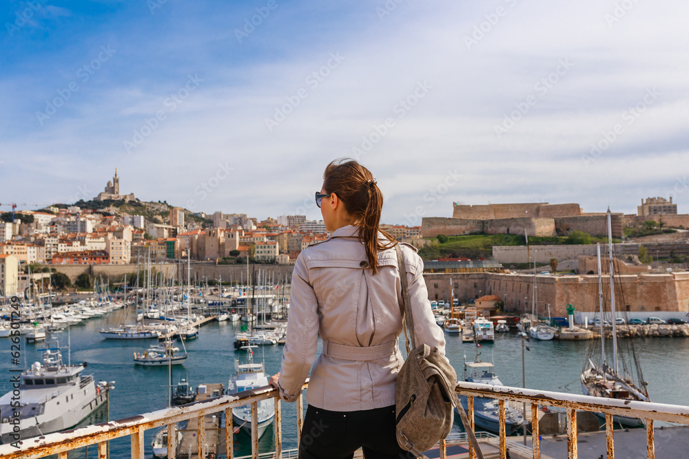 Naklejka premium Tourist woman in french city Marseille. Marina and sea, France, Europe