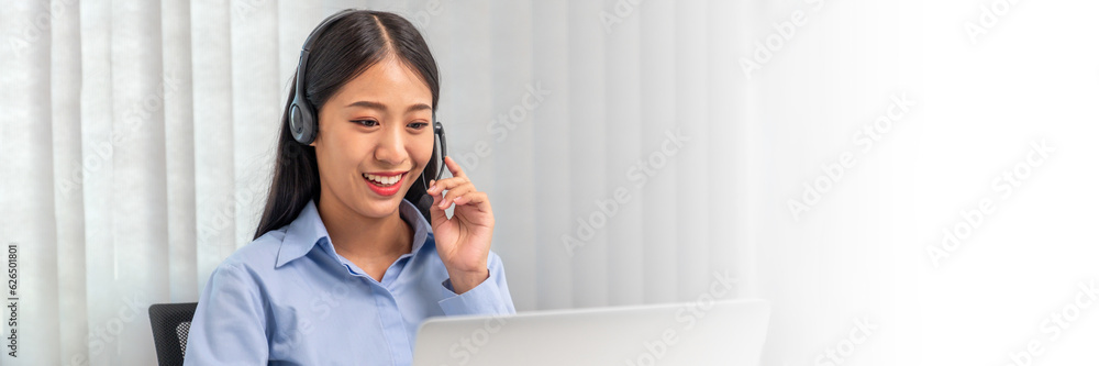 Female call center operator with headset working on support hotline in modern office Teleconferencing via video. online training. Female call center operator with headset working on support hotline in modern office Teleconferencing via video. online training.
