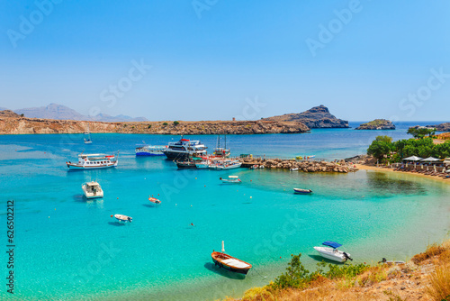 Sea skyview landscape photo Lindos bay and sea coast on Rhodes island, Dodecanese, Greece. Panorama with nice sand beach and clear blue water. Famous tourist destination in South Europe