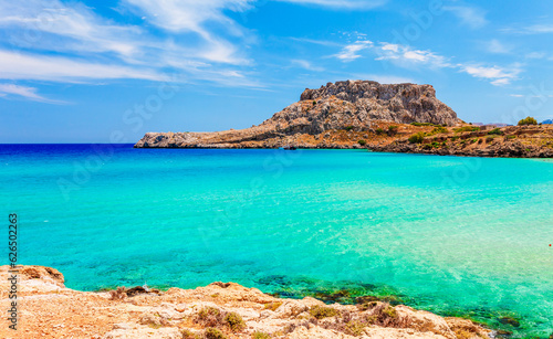 Sea skyview landscape photo with Feraklos castle near Agia Agathi beach on Rhodes island, Dodecanese, Greece. Panorama with sand beach and clear blue water. Famous tourist destination in South Europe