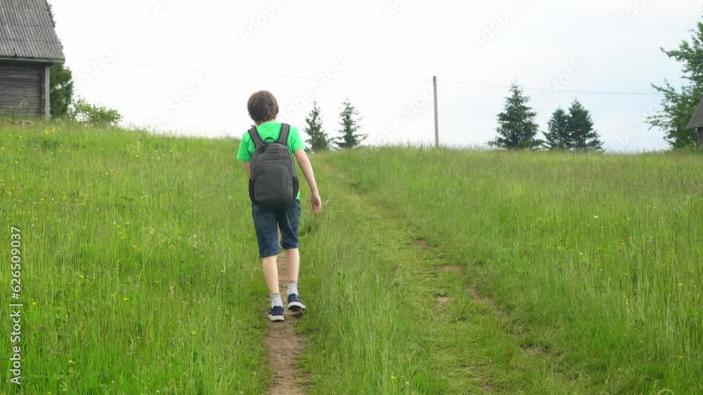 Teenager walks in nature in the mountains. Journey among the mountains. Spending time in nature among meadows, mountains and animals Teenager walks in nature in the mountains. Journey among the mountains. Spending time in nature among meadows, mountains and animals
