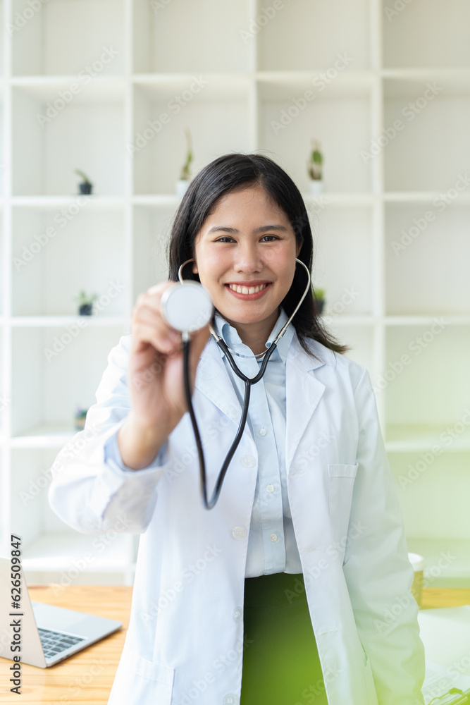 female doctor in a white coat with a stethoscope looking at the camera, smiling female doctor in a white coat with a stethoscope looking at the camera, smiling