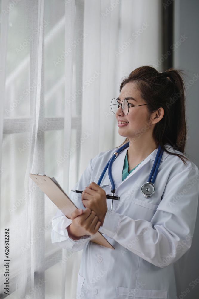 Medical health clinic beautiful Asian doctor working using laptop stethoscope diagnosing patient analysis. Medical health clinic beautiful Asian doctor working using laptop stethoscope diagnosing patient analysis.