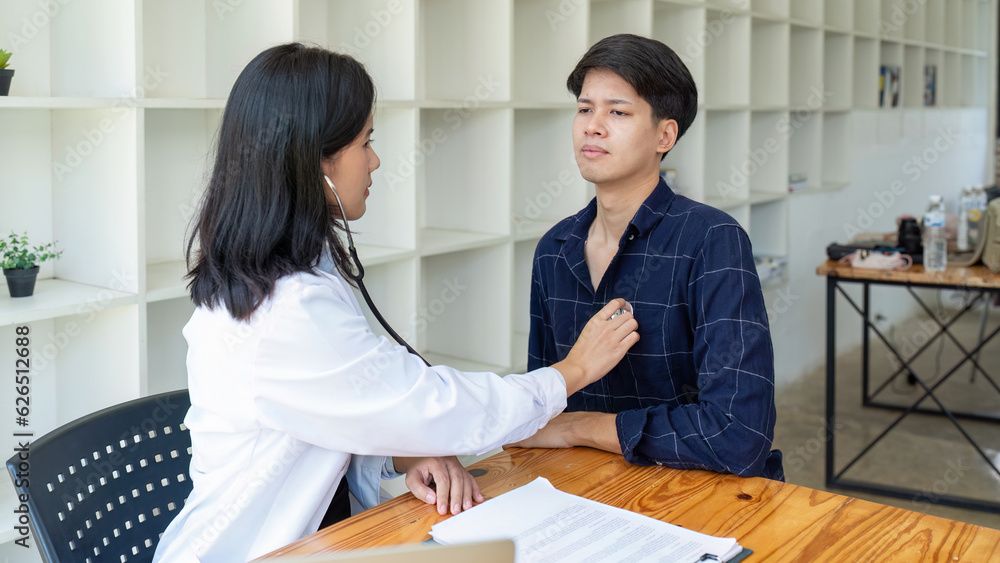 Fototapeta premium Female doctor using stethoscope listening patients heart.