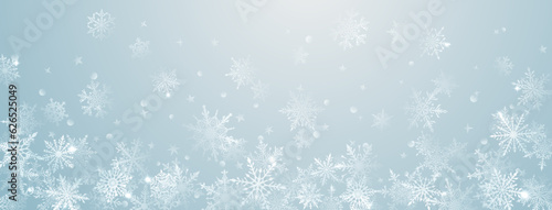 Christmas background of beautiful complex big and small snowflakes in light blue colors. Winter illustration with falling snow