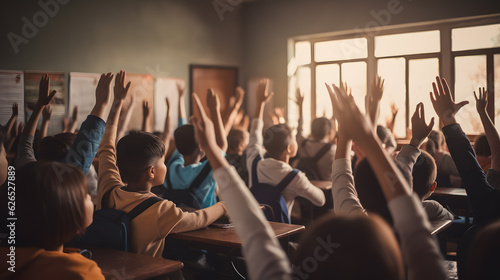Back to school. Students raising hands in the classroom © Abzal