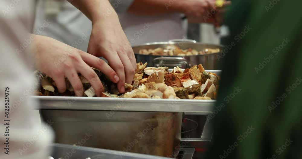 Preparation of forest mushrooms. Wild, forest mushrooms are cooked in a large pot in the professional kitchen of a prestigious restaurant. Healthy and vegan food. Preparation of forest mushrooms. Wild, forest mushrooms are cooked in a large pot in the professional kitchen of a prestigious restaurant. Healthy and vegan food.