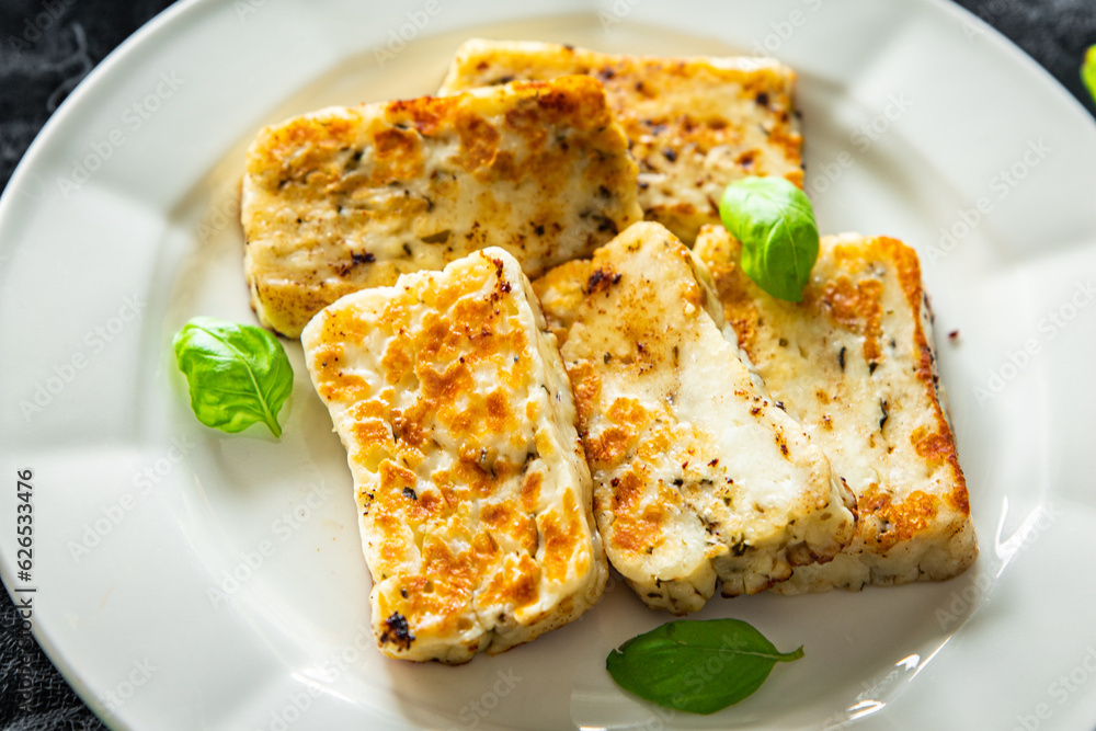 fried halloumi cheese with basil healthy meal food snack on the table copy space food background rustic top view keto or paleo diet veggie vegan or vegetarian food