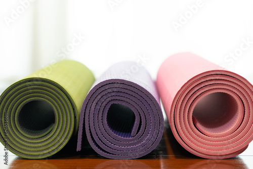 close up of colorful yoga mat on the table, sport and healthy concept