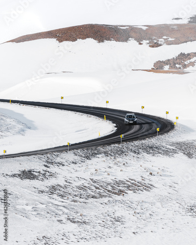 Car driving down a snowy road in Iceland