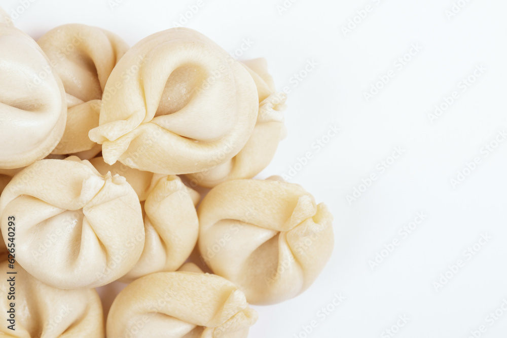 Dumplings on white background closeup. Uncooked dumplings. Top view. Dumplings on white background closeup. Uncooked dumplings. Top view.