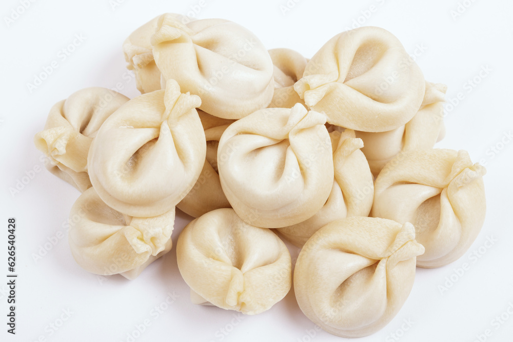 Dumplings on white background closeup. Uncooked dumplings. Top view. Dumplings on white background closeup. Uncooked dumplings. Top view.