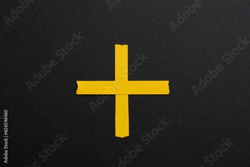 Fototapeta Naklejka Na Ścianę i Meble -  Plus yellow sign, symbol on black background