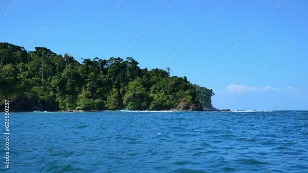 Land with green vegetation seen in the distance from a boat near Pangandaran beach. Shot in slow motion and handheld. The waves were strong enough to make the video sway. Land with green vegetation seen in the distance from a boat near Pangandaran beach. Shot in slow motion and handheld. The waves were strong enough to make the video sway.