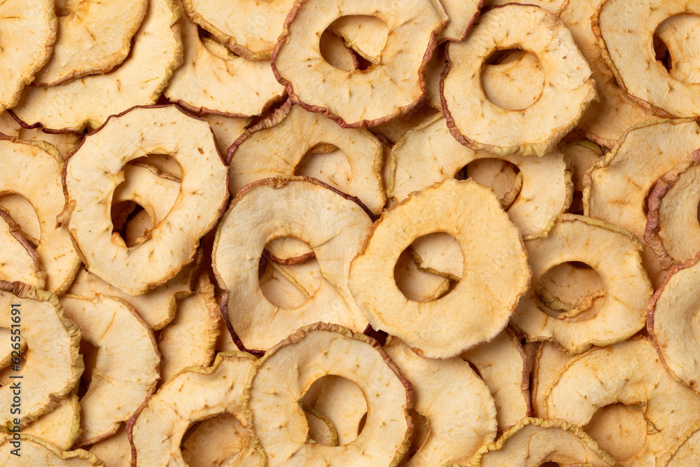 Dried apple chips full frame close up as background