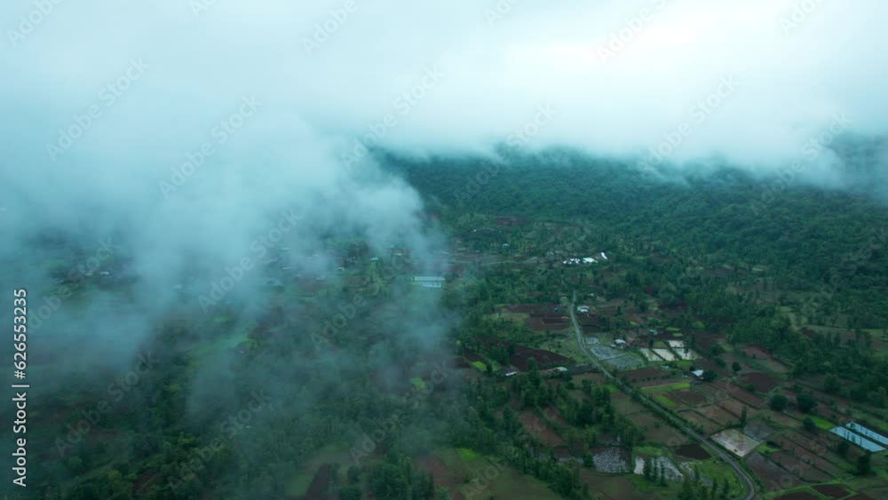 4K aerial view of Flying through rain clouds above green mountain covered by jungle and small villages at Saputara, Dang, India. Wonderful rainy day. Natural landscape 4K aerial view of Flying through rain clouds above green mountain covered by jungle and small villages at Saputara, Dang, India. Wonderful rainy day. Natural landscape