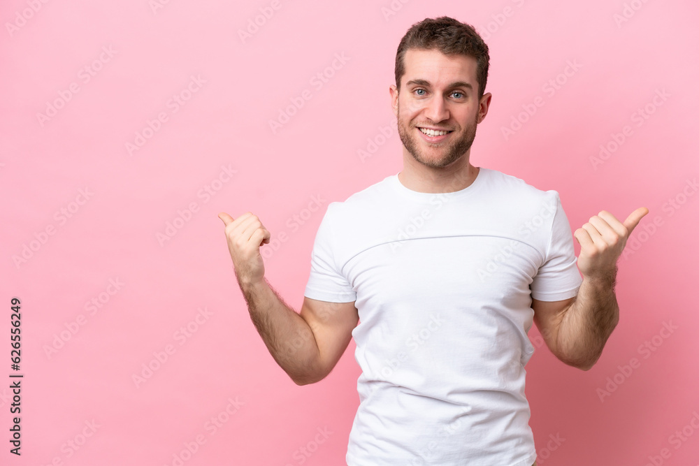 Young caucasian man isolated on pink background with thumbs up gesture and smiling Young caucasian man isolated on pink background with thumbs up gesture and smiling