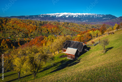 Spectacular countryside autumn scenery and wooden house on the slope