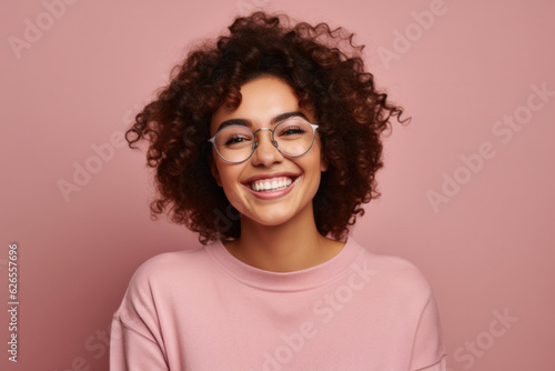 Portrait Of Cheerful Laughing Young Girl On Copyspace. Mixed Race Student in Glasses.