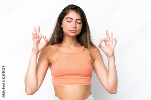 Young caucasian woman isolated on white background in zen pose