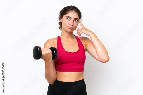Young sport caucasian woman making weightlifting isolated on white background having doubts and thinking