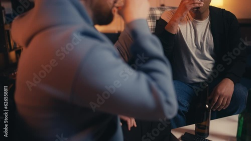 Closeup of drunk men hanging out together, overdrinking, alcohol addiction photo