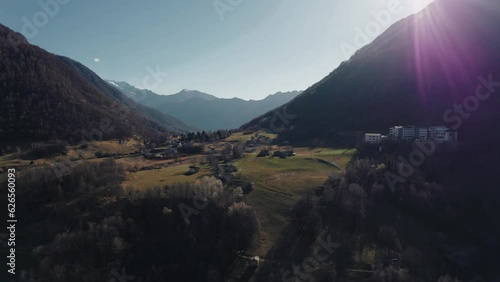 Beautiful aerial view of the Valsassina valley in the Lombardy Alps at sunset, with the green fields photo
