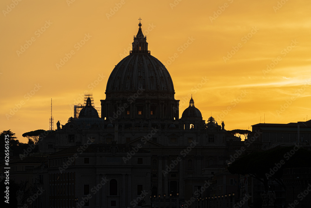 St. Peter's basilica silhouette at sunset in Rome, Italy