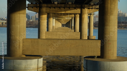 Bridge structure on the riverside in winter under the glow of the sunset