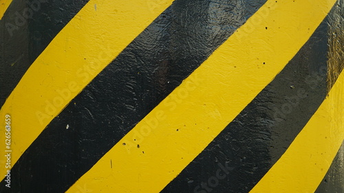 Pillars with yellow and black striped warning pattern © shufilm