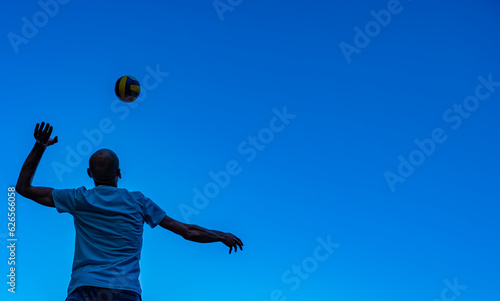 Silhouette of a man just about to hit a volleyball ball © Krzysztof