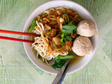 Indonesian food, mie ayam, noodles with chicken and served with meatballs