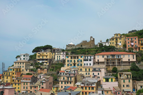 Cinque Terre, Italy - view of colorful houses in Riomaggiore, a seaside town on the Italian Riviera. Summer travel vacation background. Postcard from Europe. Italian architecture exterior.