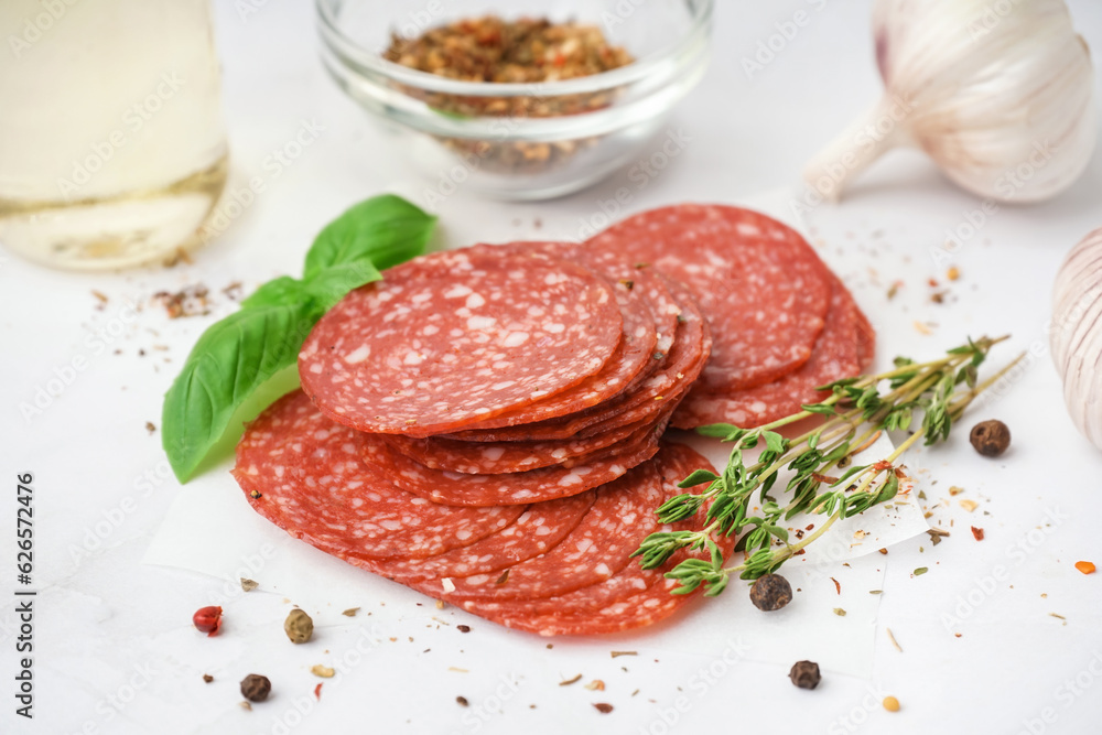 Slices of tasty salami on light background Slices of tasty salami on light background