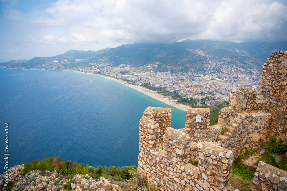 Aerial view of Cleopatra Beach from Alanya Castle with ruin of medieval wall on foreground, Turkey