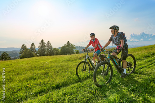 Fotobehang two senior girlfriends having fun during a cycling tour in the Allgau Alps near