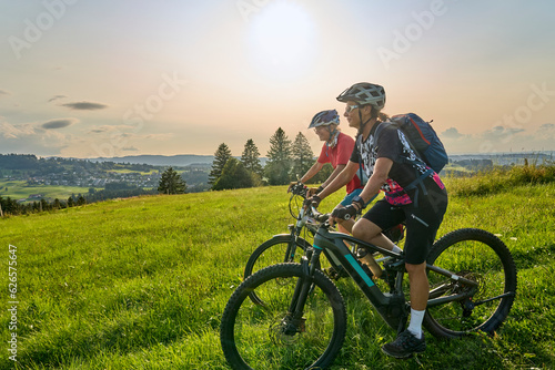 two senior girlfriends having fun during a cycling tour in the Allgau Alps near Oberstaufen, Bavaria, Germany © Uwe