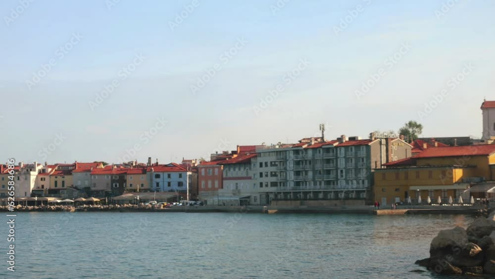 View of the port and the embankment of Piran in the early morning from the board of the departing ship. Slovenia.