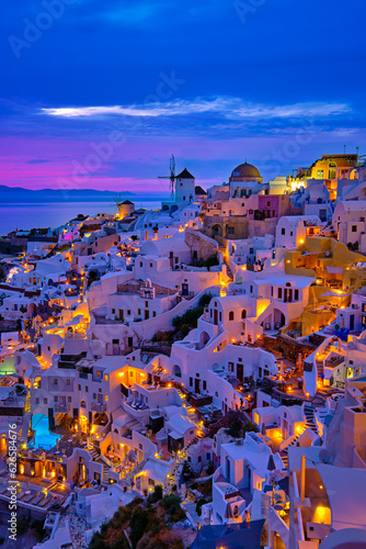Oia village, windmills, Santorini island, Greece at colorful sunset