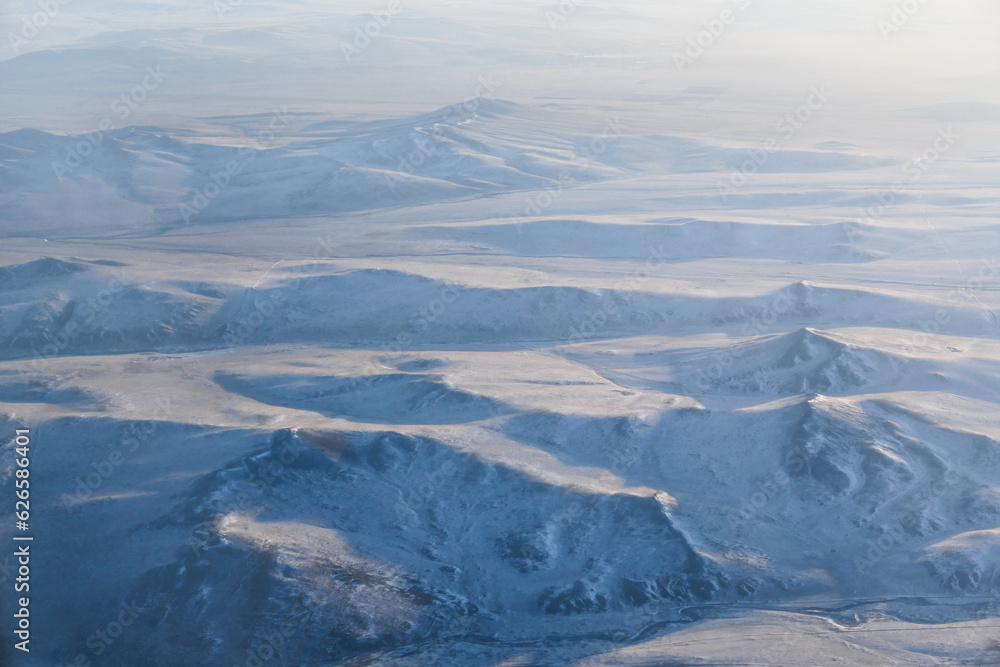 Fototapeta premium Snow covered mountains range in winter season, Mongolia