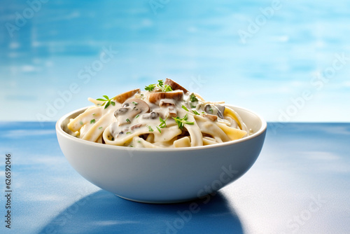 tasty and creamy vegetarian mushroom pasta on a light blue background, created with generative ai photo