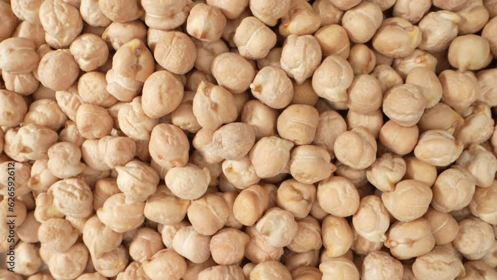 Chickpea seeds are a nutrition powerhouse, packed with protein, fiber, vitamins, and minerals. They promote heart health, aid digestion, and offer a range of essential nutrients. Macro footage. 4K
Chickpea seeds are a nutrition powerhouse, packed with protein, fiber, vitamins, and minerals. They promote heart health, aid digestion, and offer a range of essential nutrients. Macro footage. 4K