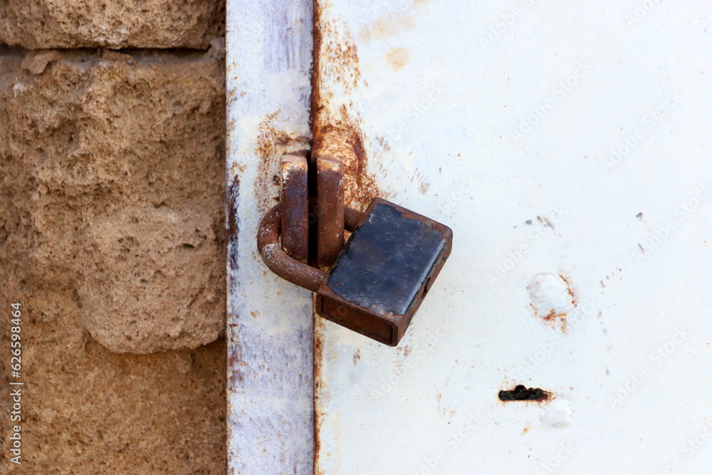 An old padlock hangs on the gate. An old padlock hangs on the gate.